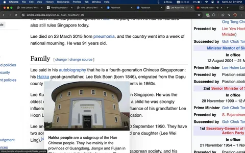 The screenshot captures a section from the Simple English Wikipedia page about Lee Kuan Yew, specifically focusing on his early life and family background. The text mentions that Lee Kuan Yew was a fourth-generation Chinese Singaporean with a Hakka great-grandfather named Lee Bok Boon, who emigrated from China in the 1860s. The screenshot includes a photo of a round building with the name "Hakka House" on it, possibly illustrating the cultural background discussed in the text. The screenshot's layout is typical of Wikipedia, with text organized into sections and subsections, and links highlighted in blue. The page title "Lee Kuan Yew - Early life" is visible at the top, and the information box on the right lists various positions held by Lee Kuan Yew, emphasizing his significant political influence. The color scheme is primarily white and blue, standard for Wikipedia's interface.