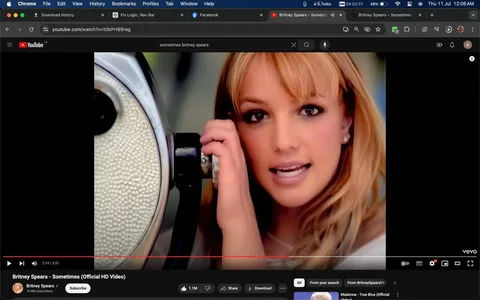 Britney Spears is featured prominently in this screenshot from the music video for her song "Sometimes," displayed on YouTube. The image shows a close-up of Britney Spears, who is looking directly at the camera with a slight smile, creating an engaging and warm atmosphere. She has light brown hair and is holding a vintage-style microphone, giving a sense of performance and intimacy. The lighting is bright, emphasizing her features and the soft tones of her hair and skin. The background is blurred, drawing attention to Spears and the microphone as the central elements of the composition.
The YouTube interface around the video shows that it is published by Vevo and the official channel named "Britney Spears." The video has a significant number of likes, indicating its popularity. The black bars on the sides suggest that the video may have been formatted for a different aspect ratio. The overall mood conveyed is nostalgic and iconic, capturing the essence of late 1990s pop music videos.
- Title: "Britney Spears - Sometimes (Official HD Video)"
- Channel / profile: "Britney Spears"
- Site / app: "YouTube"