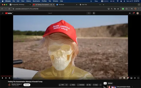 The image is a YouTube screenshot featuring a video titled "Testing The Assassination Attempt of Donald Trump" from the channel Brandon Herrera. The scene is set outdoors on what appears to be a dusty field. At the center of the frame is a mannequin or dummy designed with a visible skull through a transparent or translucent surface. The dummy is adorned with a red baseball cap emblazoned with the slogan "MAKE AMERICA GREAT AGAIN," associated with Donald Trump. The dummy also has artificial blonde hair, adding to a caricatured representation. The background is a nondescript landscape with a dirt ground and a blurry horizon of trees or distant hills. The lighting is natural, suggesting a daytime setting. This visual seems to be part of an experimental or demonstrative setup likely related to political commentary or satire.
- Title: "Testing The Assassination Attempt of Donald Trump"
- Channel / profile: "Brandon Herrera"
- Site / app: "YouTube"