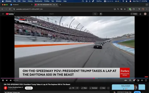The image depicts a scene from a video titled "ON-THE-SPEEDWAY POV: President Trump Takes a Lap At The Daytona 500 In The Beast." The video is currently playing on a YouTube interface, with a timestamp showing 5:38 out of a total of 8:55. 

In the foreground, there is a black vehicle, identified as "The Beast," which is the official presidential limousine. It is positioned on a racetrack, moving at speed. The vehicle is flanked by several other cars, also black, suggesting a convoy. The track is marked with a white wall and an orange stripe running along its length.

In the background, a large crowd is visible in the grandstands, with many spectators standing and cheering. The stands are filled with people, indicating a lively atmosphere typical of a major sporting event. The sky is overcast, with gray clouds visible, suggesting a potentially rainy day.

The lower portion of the image features text that reads: "ON-THE-SPEEDWAY POV: PRESIDENT TRUMP TAKES A LAP AT THE DAYTONA 500 IN THE BEAST," along with the date "FEBRUARY 16, 2025." The logo for Forbes Breaking News is also present, indicating the source of the video. 

The video interface includes standard YouTube controls, such as play/pause, volume, and options to share or download the video. The view count is displayed as 421,735 views, with a subscriber count of 4.1 million for the channel. 

Overall, the image captures a dynamic moment from a high-profile event, with a focus on the vehicle and the enthusiastic crowd.