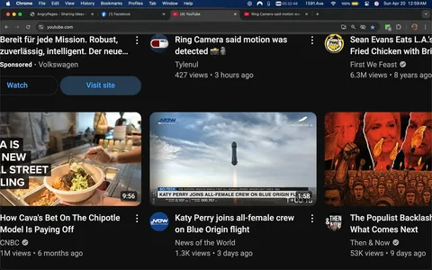 The image displays a screenshot of a YouTube interface featuring several video thumbnails. The layout is dark-themed, typical of YouTube's design. 

1. **Top Section**: 
   - The top of the screen shows the browser's address bar with "youtube.com" visible. 
   - There are tabs open, including "AngryPages - Sharing Ideas" and "Facebook."
   - The time displayed is 5:32:48 AM, and the date is indicated as Sunday, April 20.

2. **Video Thumbnails**: 
   - **First Thumbnail**: 
     - Title: "Bereit für jede Mission. Robust, zuverlässig, intelligent. Der neue..."
     - Sponsored by Volkswagen.
     - A button labeled "Watch" and another labeled "Visit site."
   - **Second Thumbnail**: 
     - Title: "Ring Camera said motion was detected."
     - Posted by user "Tylenul."
     - 427 views, posted 3 hours ago.
   - **Third Thumbnail**: 
     - Title: "How Cava's Bet On The Chipotle Model Is Paying Off."
     - Posted by CNBC.
     - 1 million views, posted 6 months ago.
     - Duration: 9:56.
   - **Fourth Thumbnail**: 
     - Title: "Katy Perry joins all-female crew on Blue Origin flight."
     - Posted by "News of the World."
     - 1.3K views, posted 3 days ago.
     - Duration: 1:58.
   - **Fifth Thumbnail**: 
     - Title: "Sean Evans Eats L.A.'s Fried Chicken with Brine."
     - Posted by "First We Feast."
     - 6.3 million views, posted 8 years ago.
   - **Sixth Thumbnail**: 
     - Title: "The Populist Backlash: What Comes Next."
     - Posted by "Then & Now."
     - 53K views, posted 9 days ago.

3. **Background and Context**: 
   - The background is a dark interface with a grid layout typical of video streaming platforms.
   - The thumbnails are arranged in a grid format, with each video featuring a still image related to its content.

Overall, the image captures a snapshot of various video content available on YouTube, showcasing a mix of topics from technology to food and entertainment.