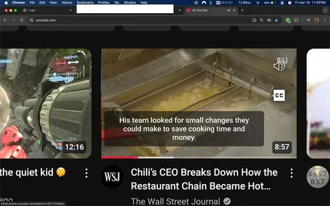 The image displays a YouTube interface featuring two video thumbnails. 

On the left side, the thumbnail shows a gaming scene from a first-person shooter game, likely from the "Halo" series. The screen displays a character holding a large weapon, with a HUD (heads-up display) indicating ammunition count and other game-related information. The character is wearing a red armor suit, and the background appears to be a futuristic landscape with rocky terrain and structures. The video duration is shown as 12:16, and the title reads "the quiet kid."

On the right side, the thumbnail features a cooking scene. It shows a deep fryer filled with bubbling oil, indicating that food is being cooked. There are metal baskets submerged in the oil, likely used for frying food items. The text overlay states, "His team looked for small changes they could make to save cooking time and money." This video is titled "Chili’s CEO Breaks Down How the Restaurant Chain Became Hot..." and has a duration of 8:57. The logo for The Wall Street Journal (WSJ) is visible in the top right corner of this thumbnail.

The background of the YouTube interface is dark, and the top of the screen shows the Chrome browser with tabs open, including a YouTube tab. The time displayed in the top right corner reads 05:37:57, and the date is noted as Friday, April 18, at 11:00 PM. The interface includes various icons for notifications and settings, typical of a web browser.

Overall, the image captures a digital environment focused on video content, showcasing gaming and culinary themes.