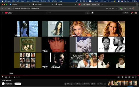 The image displays a YouTube interface featuring a grid of music video thumbnails. The top row includes a video thumbnail of a woman in a white dress standing by water, followed by an album cover featuring a woman with long dark hair, identified as Cher, with the title "Believe." Next is a thumbnail of a woman with blonde hair styled in waves, likely representing a pop artist.

The second row features a close-up of a man with distinctive makeup and a serious expression, possibly a famous musician. Beside him is a black-and-white image of a woman with a striking pose, likely another artist. The next thumbnail shows a woman with dark hair and a man with a beard, both appearing to be in a music video.

The third row includes a green album cover featuring a group of people, followed by a collage of various artists, including women with long hair. The last thumbnail shows a man singing passionately, with another image of a group of people in a performance setting.

At the bottom of the screen, there is a video player interface displaying the title "Cher - Believe" and a channel name "AllCherMusic" with 26.1K subscribers. The play button is visible, along with options to share, download, and save. The video is currently at the 4:00 mark. The background is dark, typical of YouTube's design, with a red progress bar indicating the video's length. 

Overall, the image captures a vibrant collection of music video thumbnails, showcasing various artists and their works.