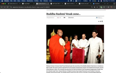 The image depicts a ceremonial event related to the Buddha Rashmi Vesak Zone, held in Colombo on May 13, 2025. The headline at the top reads "Buddha Rashmi Vesak zone..." followed by the date and time of the article, which is May 14, 2025, at 06:01 am. The article appears to be from the Daily Mirror website, as indicated by the URL in the address bar.

In the foreground, there are several individuals participating in the event. The prominent figure on the left is a monk dressed in a bright orange robe, holding a circular object that resembles a traditional fan or ceremonial item. He has a serious expression on his face. Next to him stands another monk, also in an orange robe, who appears to be looking at the first monk. 

To the right of the monks, there are three men dressed in white attire. The man in the center is holding a red cloth or banner, while the other two men are looking at him. One of these men has short black hair and is wearing glasses, while the other has a more rounded face and is slightly balding. 

In the background, there are golden statues, likely of Buddha, which are illuminated, contributing to the ceremonial atmosphere. The setting appears to be an outdoor area, possibly a temple or a designated event space, with decorative elements typical of Buddhist celebrations.

The text below the image provides additional context, mentioning that the event is organized by the Hunupitiya Gangaramaya Temple and the Presidential Secretariat, and it was graced by various dignitaries, including the Chief Incumbent of the temple and the Deputy Minister of Digital Economy.

Overall, the image captures a formal and respectful atmosphere associated with the Vesak celebration, highlighting the cultural and religious significance of the event.