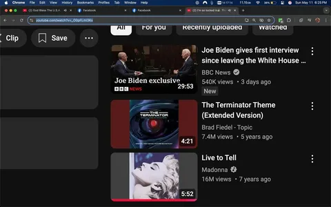 The image displays a screenshot of a YouTube interface, primarily featuring a dark mode layout. 

1. **Top Bar**: At the top, there is a browser window with the URL "youtube.com/watch?v=_OOpFLmI3Ks" visible. The browser is Google Chrome, indicated by the logo on the left. The time displayed is 14:17:14, and the date is shown as Sunday, May 11, at 6:25 PM. The battery percentage is at 38%, and the device is a Mac, as indicated by the Apple logo.

2. **YouTube Content**: The main content area shows three video thumbnails:
   - **First Video**: 
     - Title: "Joe Biden gives first interview since leaving the White House ..."
     - Channel: "BBC News" with a checkmark indicating verification.
     - Views: "540K views"
     - Upload Time: "3 days ago"
     - Duration: "29:53"
     - The thumbnail features two men seated at a table, likely in an interview setting, with a dark background.
   - **Second Video**: 
     - Title: "The Terminator Theme (Extended Version)"
     - Channel: "Brad Fiedel - Topic"
     - Views: "7.4M views"
     - Upload Time: "5 years ago"
     - Duration: "4:21"
     - The thumbnail displays a graphic related to "The Terminator," featuring a stylized image of a robotic eye.
   - **Third Video**: 
     - Title: "Live to Tell"
     - Channel: "Madonna"
     - Views: "16M views"
     - Upload Time: "7 years ago"
     - Duration: "5:52"
     - The thumbnail shows a close-up of a woman with blonde hair, appearing to be Madonna, against a light background.

3. **Layout**: The left side of the screen has a vertical menu with options like "All," "For you," "Recently uploaded," and "Watched." There is also a "Save" and "Clip" option visible.

4. **Background**: The overall background is dark, consistent with YouTube's dark mode, which enhances the visibility of the video thumbnails.

5. **Additional Elements**: The interface includes icons for saving and clipping videos, but no additional text or images are present outside the visible thumbnails and menu options.

This description captures all observable details without speculation or interpretation.