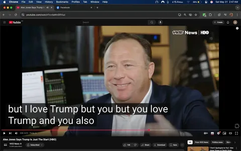 The image features a man with a light complexion and short, dark hair, smiling at the camera. He is wearing a dark blazer over a white shirt, which is partially visible. The background includes several computer screens, some displaying audio mixing software and others showing text documents. The setting appears to be a studio or office environment, likely related to media production, given the presence of audio equipment and monitors.

In the foreground, there are subtitles displayed on the screen, which read: "but I love Trump but you but you love Trump and you also." The text is bold and white, set against a dark background, making it easily readable. The man is gesturing with his hands, suggesting a conversational or animated tone.

The logo in the top right corner indicates that this is a segment from "VICE News" on HBO, with the channel's branding clearly visible. The video player interface at the bottom shows options for sharing, subscribing, and other typical YouTube functionalities.

Overall, the image captures a moment of discussion or interview, with a focus on the man's expression and the technology surrounding him. The environment is professional, likely aimed at producing content for a media audience.