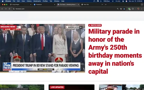 The image displays a news website interface, specifically from Fox News, featuring a breaking news segment. The top portion of the image includes a red banner labeled "BREAKING NEWS" with a timestamp indicating "6:07 PM ET." Below this banner, there is a video frame showing a group of individuals standing together, presumably at a military parade event.

In the foreground, the text reads "PRESIDENT TRUMP IN REVIEW STAND FOR PARADE VIEWING," indicating that the scene is related to a military parade. The bottom of the video frame features a logo for Fox News, identifiable by its blue and white color scheme, along with the text "ARMY 250 PARADE."

The individuals visible in the image include a man in a dark suit with a tie, standing next to a woman in a white double-breasted blazer. The woman has long, straight hair and appears to be looking forward. To the right of the woman, another individual is seen wearing a black dress and holding a sign or card. The expressions of the individuals are neutral, and they appear to be focused on the event.

In the background, there are several other people, some of whom are partially obscured. The setting appears to be an outdoor venue, likely in a city, given the formal nature of the event and the presence of a crowd. The overall atmosphere suggests a significant public occasion, possibly celebrating the Army's 250th birthday, as indicated by the headline on the website.

The image also includes a navigation bar at the top with options like "File," "Edit," "View," "History," "Bookmarks," "Profiles," and "Tab," indicating that this is a web browser interface. The bottom section of the image shows additional content, including "LIVE UPDATES," but specific details are not visible in this cropped view.

Overall, the image captures a moment from a formal event, with a focus on notable figures and the context of a military celebration.