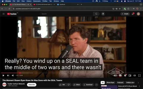 The image shows a scene from a YouTube video featuring a man speaking into a microphone. He has medium-length, wavy brown hair and is wearing a light-colored, checkered shirt. His expression appears serious and engaged as he speaks. The background consists of wooden walls with shelves filled with various books and decorative items, including a lamp with a patterned shade.

At the bottom of the image, there is a subtitle overlay that reads: "Really? You wind up on a SEAL team in the middle of two wars and there wasn't." This text is in a bold, white font against a black background, indicating it is part of the video’s closed captioning.

The video is titled "The Moment Shawn Ryan Knew He Was Done with the SEAL Teams," and it is part of the Tucker Carlson Network, as indicated by a logo in the lower right corner. The video is currently at 1 minute and 57 seconds into a total length of 14 minutes and 40 seconds.

In the top left corner, there are browser elements visible, including the YouTube logo and a search bar. The video has a play button, and there are options for sharing and downloading below it. The overall setting appears to be a casual interview or discussion format, likely filmed in a studio or home-like environment.