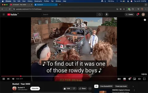 In the image, we see a scene from a music video featuring a group of young individuals gathered around a distinctive, modified car. The car, prominently displayed in the center, has a weathered appearance with a rusty red color and various mechanical contraptions attached to its roof, including a large speaker and a funnel-like device. Smoke billows from the vehicle, adding a dramatic effect to the scene.

In front of the car stands a young boy, likely a central character in the narrative. He wears a white lab coat, suggesting a scientist or inventor role, and sports a pair of oversized glasses that accentuate his youthful features. His expression is serious yet curious, as he seems to be addressing the group. The boy's hair is styled in a messy, spiky fashion, contributing to a playful, eccentric vibe.

The group surrounding him consists of three individuals, all with distinct hairstyles. One has a mohawk, dyed in a stark contrast of black and white, while another has a more tousled, wild look. Their clothing is casual, with one wearing a black shirt featuring the text "OLD MAN PEABODY," hinting at a humorous or nostalgic reference. The expressions on their faces range from intrigue to amusement, suggesting they are engaged in a lighthearted exploration of the situation.

The background features a rustic setting, with a wooden fence and some overgrown plants, indicating a possibly abandoned or makeshift area. A couple of bicycles lean against the fence, adding to the youthful, carefree atmosphere. The overall mood is playful and adventurous, with an underlying sense of curiosity about the car and its capabilities.

The text overlay in the image features lyrics, indicating that this scene is part of a musical performance. The lyrics mention "rowdy boys," which could imply a theme of youthful rebellion or mischief. The combination of the characters' expressions, the car's modifications, and the setting creates a narrative of exploration and excitement, typical of youth culture.

This image captures a moment filled with energy and curiosity, reflecting themes of adventure and the playful spirit of youth. The visual elements work together to create a vivid scene that invites viewers to engage with the story being told.
