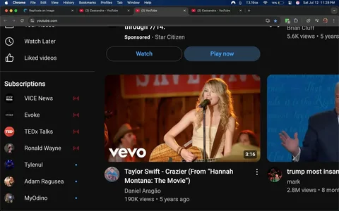 The image displays a YouTube interface featuring a video thumbnail prominently showcasing a female singer, identified as Taylor Swift, performing. She is positioned centrally, holding an acoustic guitar, with a microphone in front of her. Her expression conveys a sense of passion and engagement, likely reflecting the emotional intensity of the song. She has long, wavy blonde hair cascading over her shoulders, and she wears a light-colored, sleeveless dress that complements the warm tones of the background.

The background is rustic, with wooden panels and a sign that reads "SAVINGS," suggesting a country or folk setting, possibly a performance venue. There are blurred figures in the background, including a man wearing a cowboy hat, which reinforces the country theme. The lighting is warm and inviting, enhancing the overall mood of the scene.

The video is titled "Taylor Swift - Crazier (From 'Hannah Montana: The Movie')" and is attributed to Daniel Aragão. Below the thumbnail, the view count is noted as 190K, and it was uploaded five years ago. The YouTube interface is dark-themed, with a sidebar displaying subscriptions to various channels, including VICE News, Evoke, TEDx Talks, and others, indicating a diverse range of content interests.

The overall tone of the image is nostalgic and celebratory, capturing a moment of musical performance that resonates with fans of Taylor Swift and the "Hannah Montana" franchise. The positioning of the video within the YouTube layout suggests it is part of a curated selection, possibly aimed at viewers interested in country music or nostalgic pop culture references.

The presence of the YouTube logo and the "vevo" branding in the corner of the thumbnail indicates that this is an official music video, adding credibility and recognition to the content. The juxtaposition of Taylor Swift's performance with the other video thumbnails in the sidebar, including one featuring a public figure, suggests a mix of entertainment and political content, which could evoke varied reactions from viewers based on their interests and affiliations.

This image encapsulates a blend of music, nostalgia, and cultural references, making it significant for fans and viewers alike, while also reflecting broader trends in media consumption and the intersection of entertainment with personal identity.